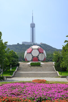 A large soccer ball sculpture is situated in front of the TV Tower at Dalian Lab