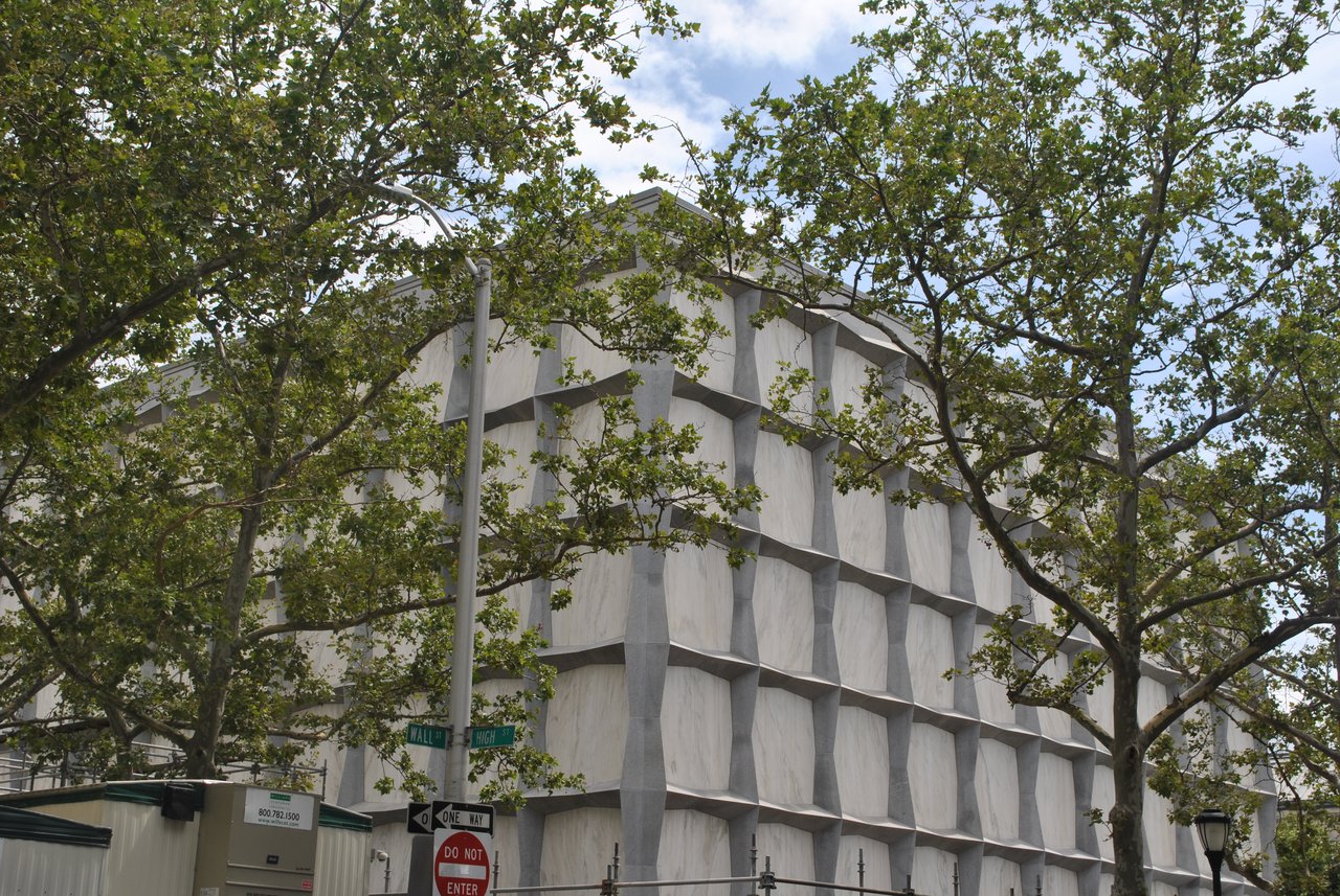 A closer view of Beinecke’s marble-and-granite facade, partly screened by trees