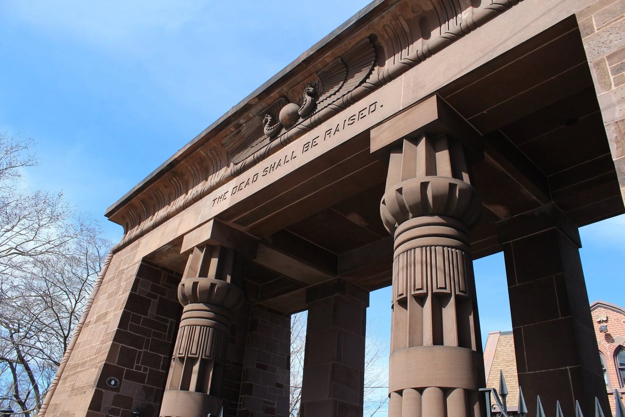The Egyptian Revival gateway and iron fence