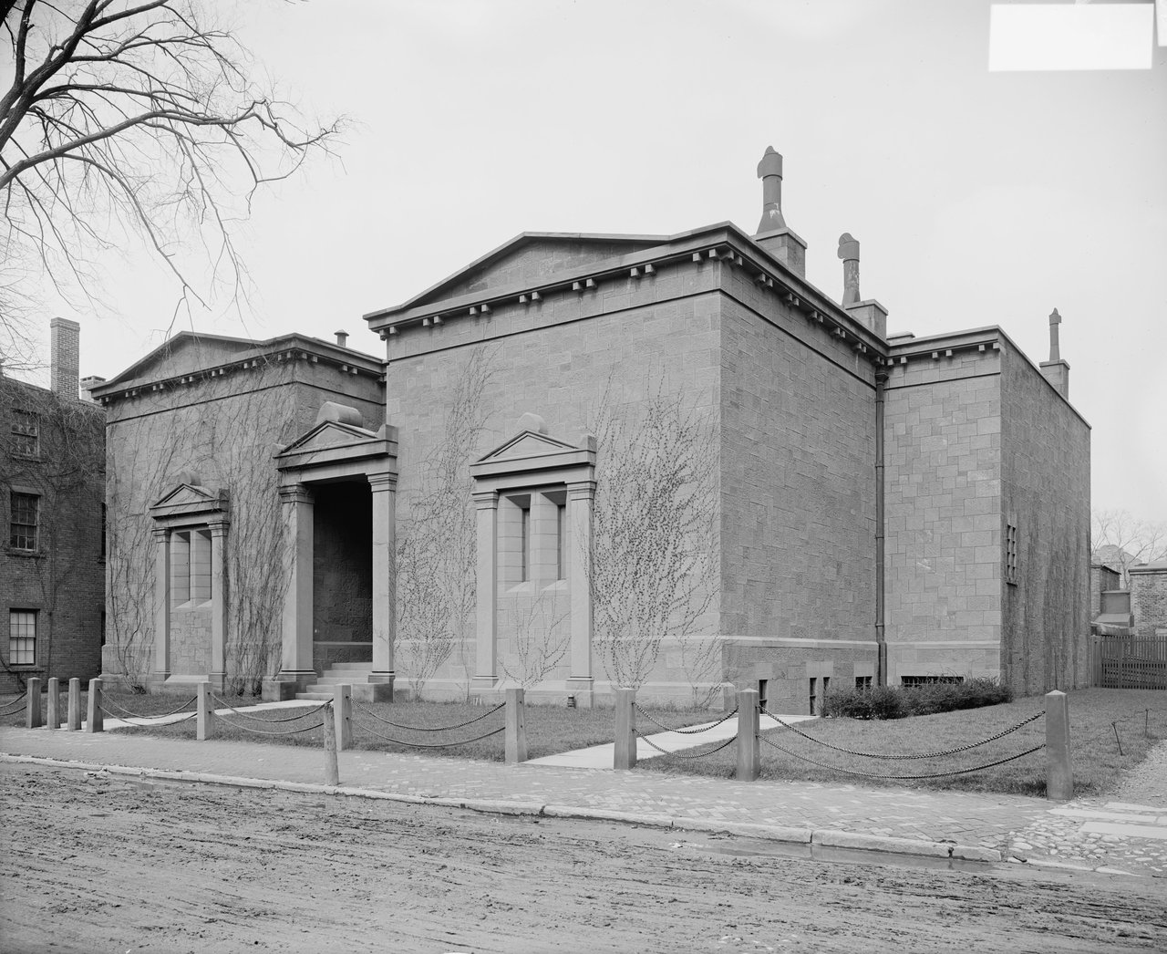 Historic black-and-white view of the enlarged Skull and Bones building, showing the central entrance, paired blind bays, and multiple blocks