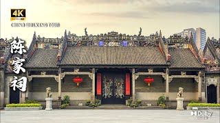 The ornate roof of a traditional Chinese building accompanied by intricate decorative details, red lanterns, and stone c