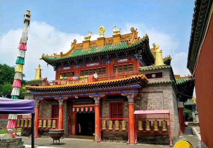 A traditional Tibetan Buddhist temple with ornate architecture, colorful decorat