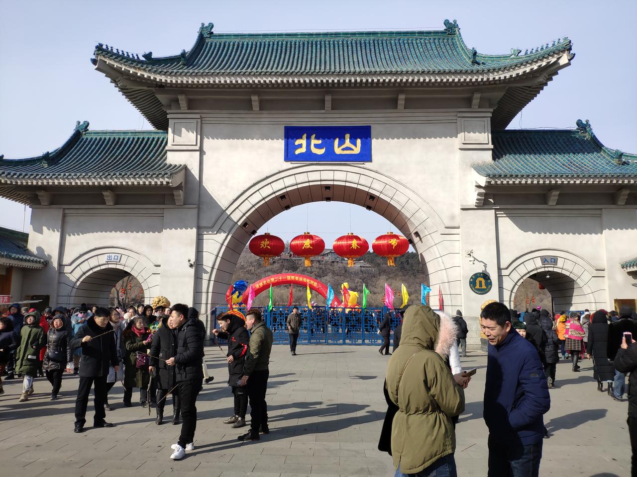 北山公园入口，庙会期间人潮涌动，红灯笼高挂