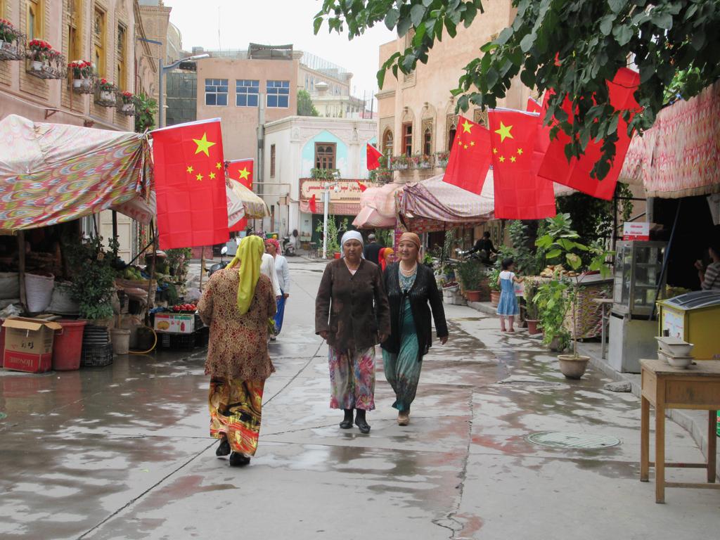 阿热亚路街景，沿街建筑悬挂国旗，底层为商铺