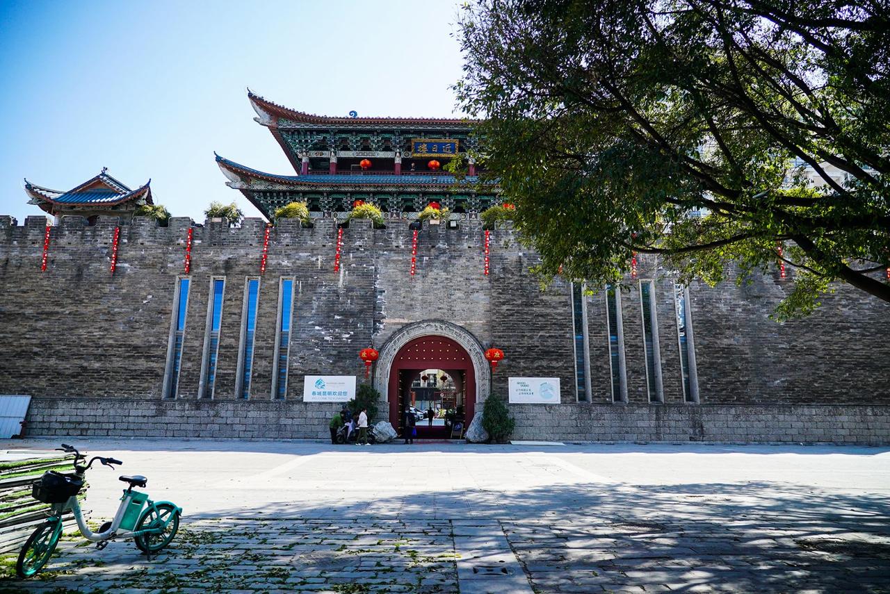 近日楼城楼近景：蓝底金字匾额、重檐歇山顶、绿色琉璃瓦、红色灯笼