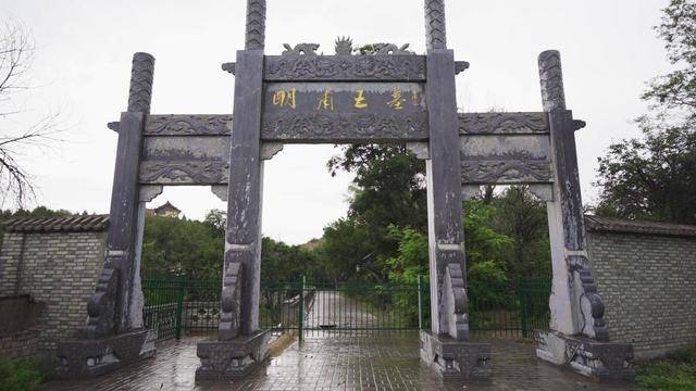 An elaborate stone archway with traditional Chinese architectural elements and i
