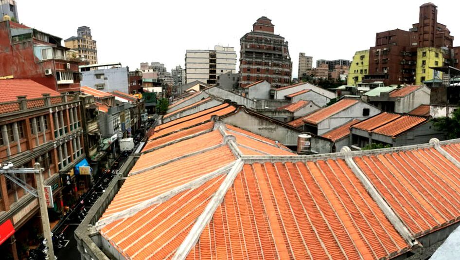 A view of Taipei's Dadaocheng area with traditional orange-tiled rooftops and a 