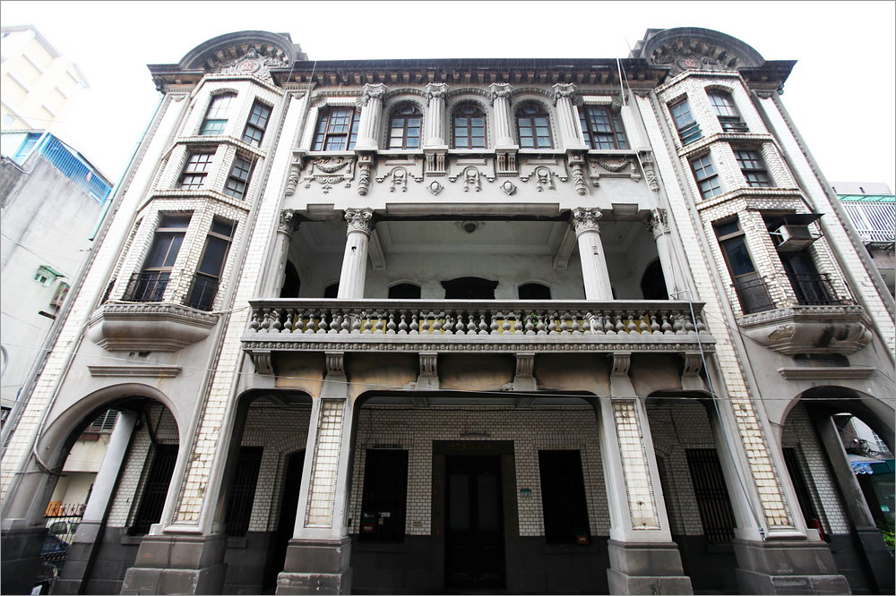 A historic, ornate building with classical architectural details, featuring colu