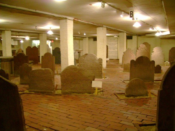 Crypt interior showing rows of in situ tombstones preserved beneath Center Church