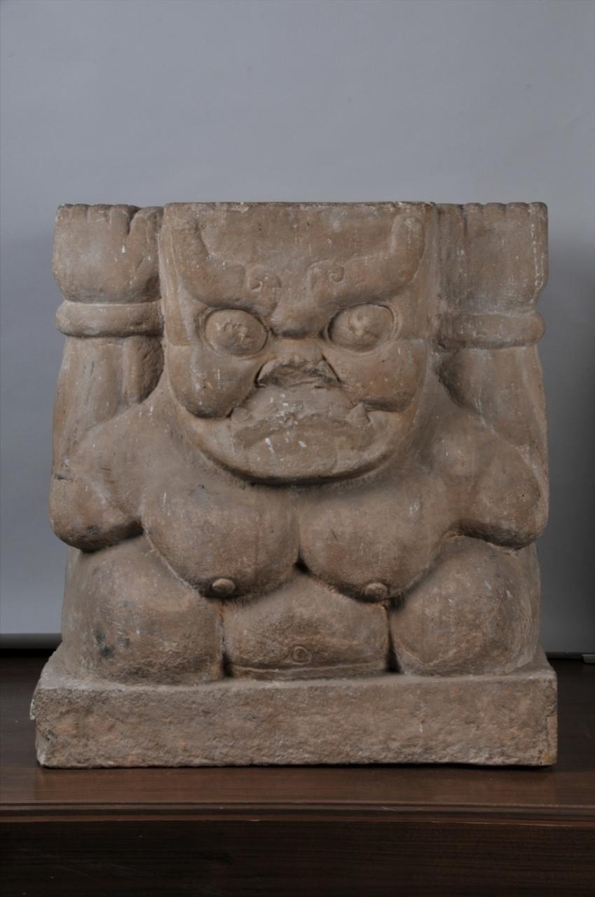 A weathered stone stele displays ancient Western Xia inscriptions and carvings o